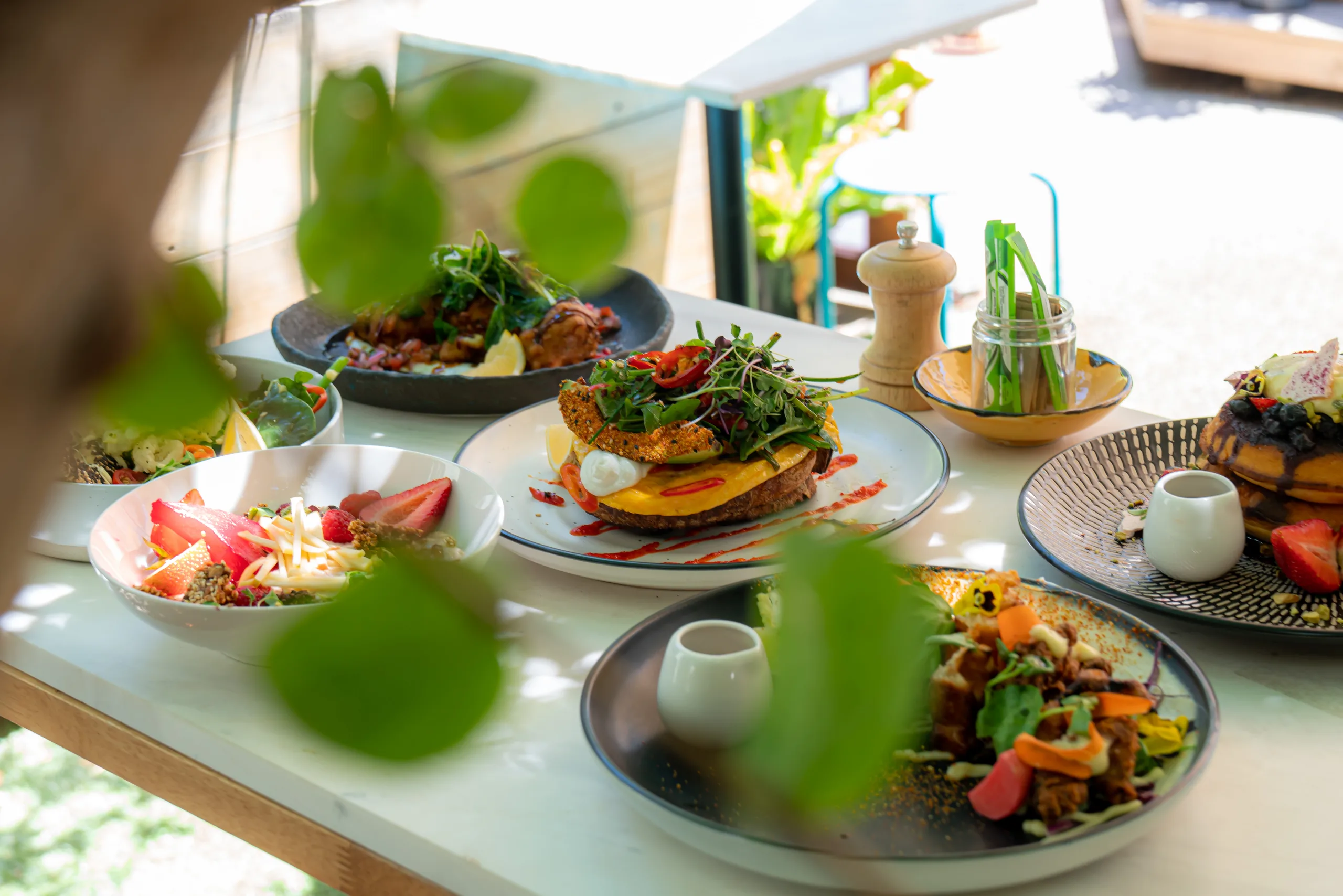 Brunch plates on a table among the plants at The Peacock