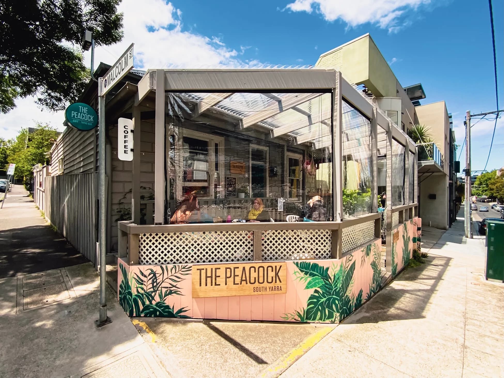 The Peacock café shopfront and leafy deck